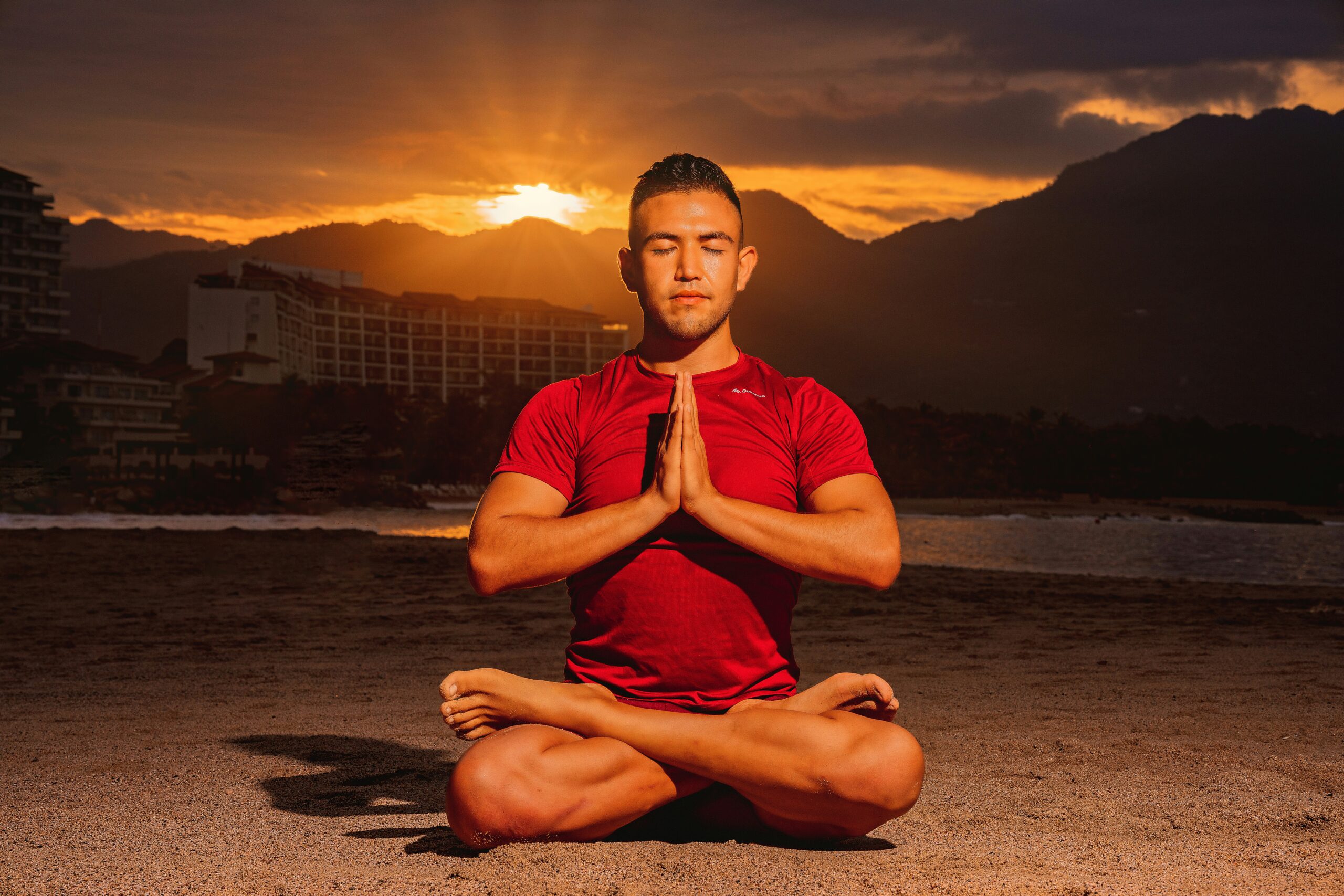 Man practicing pranayama breathing exercise in seated yoga pose