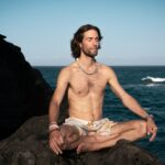 Man practicing pranayama breathing exercise in seated yoga pose