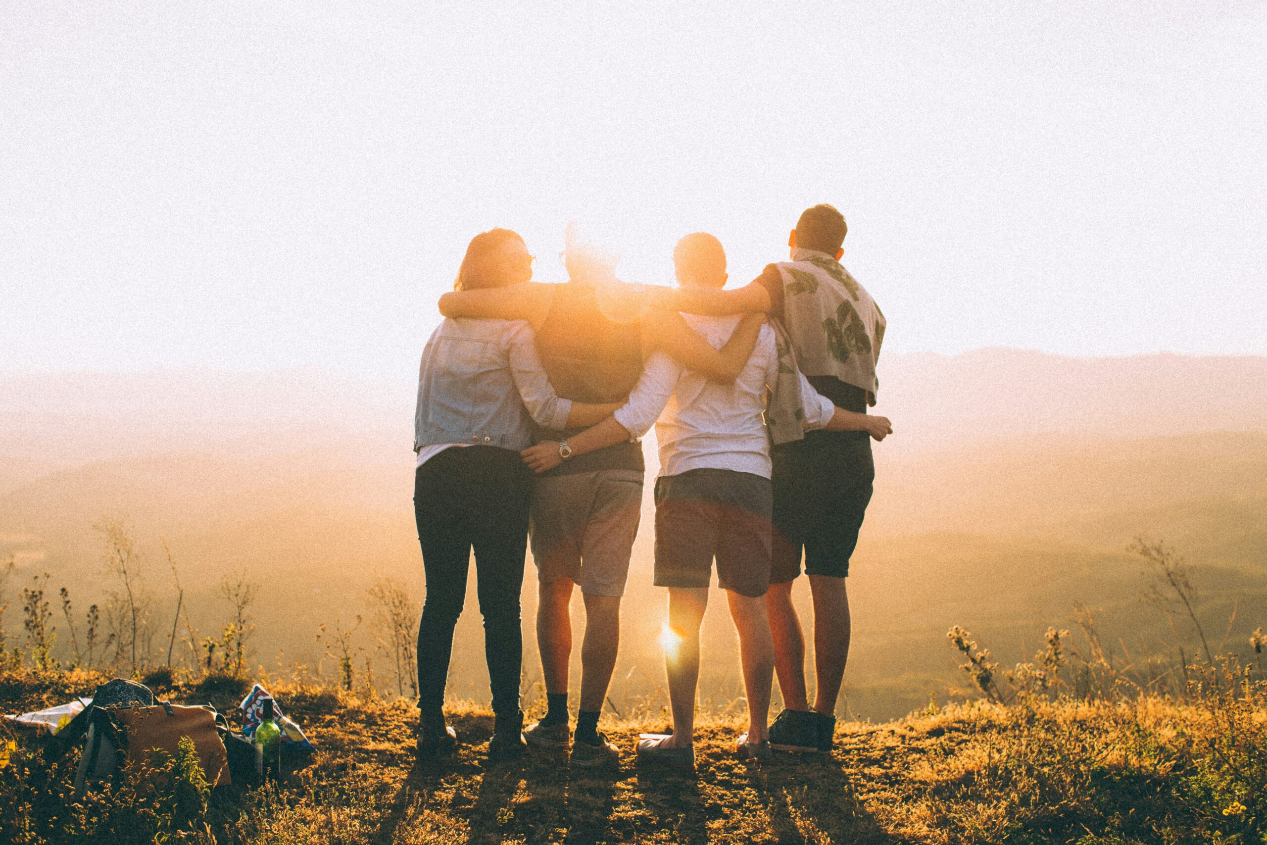 group of people hugging happy showing benefits of yoga