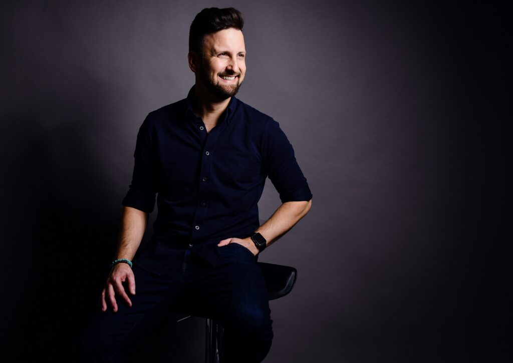 Man adjusting tie and wearing a crisp shirt to look confident and stylish